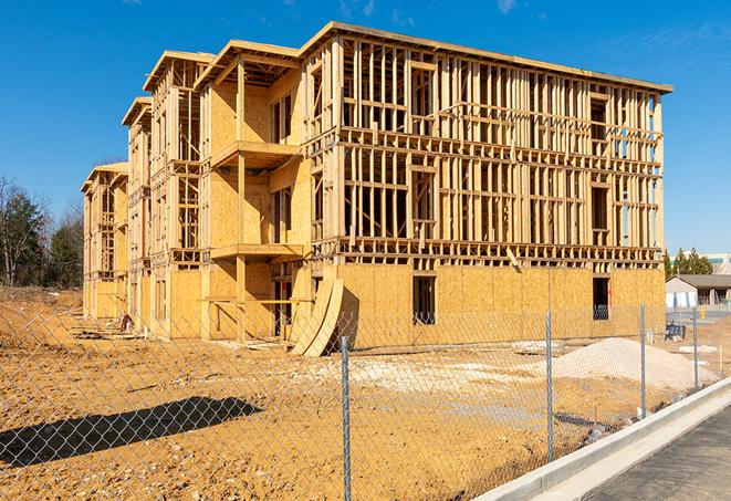 a temporary chain link fence locking away a building under renovation, serving as a security tool in Kansasville, WI